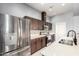 Kitchen with stainless appliances, tile backsplash, quartz counters, and ample cabinets at 1225 N 36Th St # 2081, Phoenix, AZ 85008