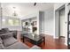 Open-concept living room with hardwood floors flowing into the kitchen breakfast bar at 1225 N 36Th St # 2081, Phoenix, AZ 85008