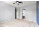 Main bedroom with ceiling fan, carpet floors, and ensuite bathroom at 1225 N 36Th St # 2081, Phoenix, AZ 85008