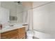 Bathroom featuring oak cabinets, large mirror, and shower over tub combination at 12841 N 19Th St, Phoenix, AZ 85022
