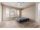 Bright bedroom with light walls, wood-look tile flooring, and plantation shutters for natural light at 12841 N 19Th St, Phoenix, AZ 85022