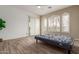 Bedroom features ceiling fan, shutters, and access to a patio at 12841 N 19Th St, Phoenix, AZ 85022