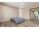 Neutral bedroom with a view into the primary bathroom and access to a laundry room at 12841 N 19Th St, Phoenix, AZ 85022