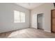 Well-lit bedroom featuring wood-look floors, closet, ceiling fan, and a large window with blinds at 12841 N 19Th St, Phoenix, AZ 85022