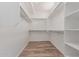 Spacious walk-in closet with built-in shelving and wood-look flooring, providing ample storage at 12841 N 19Th St, Phoenix, AZ 85022