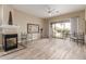 Spacious living room with a fireplace, tile floors, and sliding glass doors to a patio with mountain views at 12841 N 19Th St, Phoenix, AZ 85022
