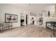 Open-concept living area flows into a kitchen featuring stainless steel appliances and a breakfast bar at 12841 N 19Th St, Phoenix, AZ 85022