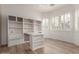 Bright office featuring custom built-ins, ample shelving and natural light from shuttered windows at 12841 N 19Th St, Phoenix, AZ 85022