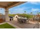 Inviting outdoor patio with dining furniture, built-in barbecue, pizza oven and desert views at 12841 N 19Th St, Phoenix, AZ 85022