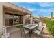 A cozy covered patio with outdoor seating, grill, desert landscaping, and a tranquil ambiance at 12841 N 19Th St, Phoenix, AZ 85022