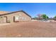 Spacious backyard with gravel ground cover, offering plenty of potential and a side entry door at 1289 E Palo Blanco Way, Gilbert, AZ 85296