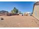 Expansive backyard with gravel, block wall, mature trees, and plenty of room for customization at 1289 E Palo Blanco Way, Gilbert, AZ 85296