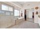 Bright bathroom featuring a glass shower, soaking tub, and closet at 1289 E Palo Blanco Way, Gilbert, AZ 85296