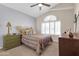 Charming bedroom featuring a large window, ceiling fan, and elegant furnishings at 1289 E Palo Blanco Way, Gilbert, AZ 85296