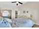 Cozy bedroom featuring a ceiling fan, large mirror, and comfortable furnishings at 1289 E Palo Blanco Way, Gilbert, AZ 85296