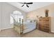 Bright bedroom with a ceiling fan, and large window with shutter, complemented by elegant decor at 1289 E Palo Blanco Way, Gilbert, AZ 85296