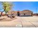Charming single-story home with decorative rock landscaping, appealing architectural details, and a three-car garage at 1289 E Palo Blanco Way, Gilbert, AZ 85296
