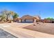 Inviting front exterior with desert landscaping, stone accents, and a spacious driveway leading to a three-car garage at 1289 E Palo Blanco Way, Gilbert, AZ 85296