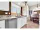 Updated kitchen sink area with stainless steel dishwasher and view into dining space at 1289 E Palo Blanco Way, Gilbert, AZ 85296