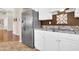 Modern kitchen featuring stainless steel refrigerator and white cabinets with granite countertops at 1289 E Palo Blanco Way, Gilbert, AZ 85296