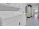 Functional laundry room with washer, dryer, sink, and ample storage space at 1289 E Palo Blanco Way, Gilbert, AZ 85296