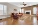 Spacious living room with hardwood floors, a fireplace, and lots of natural light from large windows at 1289 E Palo Blanco Way, Gilbert, AZ 85296