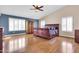 Bright main bedroom featuring hardwood floors, ceiling fan, and ample natural light at 1289 E Palo Blanco Way, Gilbert, AZ 85296