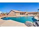 Gorgeous pool with rock features surrounded by tan concrete and a fenced yard at 1289 E Palo Blanco Way, Gilbert, AZ 85296