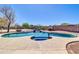 Inviting backyard pool and spa with a rock waterfall surrounded by mature desert landscaping at 1289 E Palo Blanco Way, Gilbert, AZ 85296