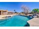Beautiful backyard pool and spa area includes lounge chairs, water features, and mature trees at 1289 E Palo Blanco Way, Gilbert, AZ 85296