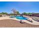 Inviting backyard pool area featuring a diving board and rock waterfall at 1289 E Palo Blanco Way, Gilbert, AZ 85296