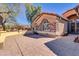 A side exterior of home with a stamped concrete patio, stylish finishes, and inviting architectural details at 1289 E Palo Blanco Way, Gilbert, AZ 85296