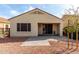 View of the home's exterior with backyard landscaping, featuring mature tree and brick pavers at 12930 W Chapala Dr, Sun City West, AZ 85375