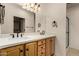 Bathroom featuring a dual sink vanity, quartz countertops, and sleek dark hardware at 12930 W Chapala Dr, Sun City West, AZ 85375