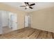 Spacious bedroom showing wood-look floors, neutral walls, and access to ensuite bathroom at 12930 W Chapala Dr, Sun City West, AZ 85375