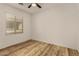 Bedroom with ceiling fan, natural light, and modern wood-look flooring at 12930 W Chapala Dr, Sun City West, AZ 85375