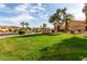 Landscaped La Quinta community entrance with lush green grass and mature trees, creating a welcoming environment at 12930 W Chapala Dr, Sun City West, AZ 85375