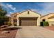 Inviting home exterior with stone accents, a brown garage door, and a desert-landscaped front yard at 12930 W Chapala Dr, Sun City West, AZ 85375
