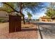 View of Corte Bella Golf Club featuring mature trees along the street and golf carts in the distance at 12930 W Chapala Dr, Sun City West, AZ 85375
