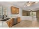 Well-lit kitchen with stainless steel appliances, tile flooring, and wooden cabinets at 12930 W Chapala Dr, Sun City West, AZ 85375
