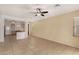Spacious living room featuring tile flooring, neutral walls, and a ceiling fan at 12930 W Chapala Dr, Sun City West, AZ 85375