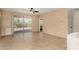 Bright living room with neutral walls, tile floors, and large sliding glass doors to the backyard at 12930 W Chapala Dr, Sun City West, AZ 85375