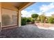 Covered patio offers a serene view of the landscaped backyard, ideal for outdoor relaxation at 12930 W Chapala Dr, Sun City West, AZ 85375