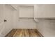 Walk-in closet with wood-look floors and ample shelving for organized storage at 12930 W Chapala Dr, Sun City West, AZ 85375