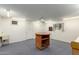 Spacious basement features lots of lighting and a central table for various activities at 13148 N 21St Ave, Phoenix, AZ 85029