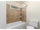 Clean bathroom featuring a tiled shower over tub, toilet, and neutral color scheme at 13148 N 21St Ave, Phoenix, AZ 85029