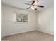 Cozy bedroom with neutral carpet, a window with blinds, and ceiling fan at 13148 N 21St Ave, Phoenix, AZ 85029