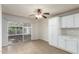 Open dining area with tiled floors, sliding glass door, white cabinets and neutral walls at 13148 N 21St Ave, Phoenix, AZ 85029