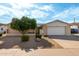 Charming single-level home with a two-car garage, desert landscaping, and a mature tree at 13148 N 21St Ave, Phoenix, AZ 85029