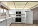 Bright kitchen features white cabinetry, black appliances and a classic tile backsplash at 13148 N 21St Ave, Phoenix, AZ 85029